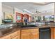 Kitchen featuring stone countertops, stainless steel appliances, and seamless bar to outdoors at 825 Regal Manor Way, Sun City Center, FL 33573