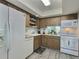 Bright kitchen with white appliances and wood cabinets at 8651 10Th N St # 118, St Petersburg, FL 33702