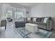 Spacious living room with gray sectional sofa and ottoman at 8651 10Th N St # 118, St Petersburg, FL 33702