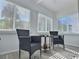 Relaxing sunroom with wicker chairs and a small table at 8651 10Th N St # 118, St Petersburg, FL 33702