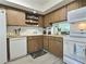 Cozy kitchen with wood cabinets and white appliances at 8651 10Th N St # 118, St Petersburg, FL 33702