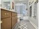 Clean bathroom with shower/tub combo and double vanity at 8651 10Th N St # 118, St Petersburg, FL 33702