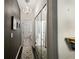 Long hallway with mirrored closet doors and a chandelier, leading to the bathroom at 2539 Silverback Ct, Palm Harbor, FL 34684