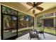 Relaxing screened patio with seating area, ceiling fan, and view of backyard at 2539 Silverback Ct, Palm Harbor, FL 34684