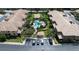 Aerial view of community, showcasing pool, building, and parking at 2539 Silverback Ct, Palm Harbor, FL 34684