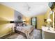 Bright bedroom with king-size bed and yellow and gray color scheme at 2539 Silverback Ct, Palm Harbor, FL 34684