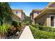 Pathway between two-story townhouses with landscaping at 2539 Silverback Ct, Palm Harbor, FL 34684