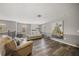 Light and airy living room with beige leather sofas and large art piece at 2539 Silverback Ct, Palm Harbor, FL 34684