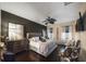 Main bedroom with dark walls, a large bed, and a TV at 2539 Silverback Ct, Palm Harbor, FL 34684