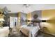 Second bedroom with king-size bed, gray and yellow color scheme, and a ceiling fan at 2539 Silverback Ct, Palm Harbor, FL 34684
