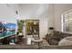 Bright living room features hardwood floors, a large TV, and sliding glass doors to a private patio at 2539 Silverback Ct, Palm Harbor, FL 34684