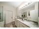 Elegant bathroom with double sinks, granite countertop, and a large walk-in shower at 2539 Silverback Ct, Palm Harbor, FL 34684