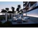 Relaxing patio area with seating and fire pit near pool at 10126 Gulf Blvd # Ph2, Treasure Island, FL 33706