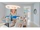 Elegant dining room with a round glass table and modern light fixture at 3401 Bayshore Blvd # 1801, Tampa, FL 33629
