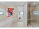 Elegant bathroom with a soaking tub, walk-in shower, and natural light at 3401 Bayshore Blvd # 1801, Tampa, FL 33629