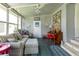 Bright sunroom with striped couch and piano at 36750 Kimela Ave, Zephyrhills, FL 33542