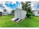 White shed with ramp access in grassy backyard at 36750 Kimela Ave, Zephyrhills, FL 33542