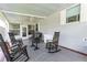 Relaxing back patio with rocking chairs and ceiling fan at 36750 Kimela Ave, Zephyrhills, FL 33542