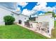 Home's backyard with patio, seating, and shed at 36750 Kimela Ave, Zephyrhills, FL 33542