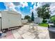 Relaxing patio area with table, chairs, and shed at 36750 Kimela Ave, Zephyrhills, FL 33542