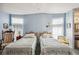 Bright bedroom with two twin beds and ample natural light at 36750 Kimela Ave, Zephyrhills, FL 33542