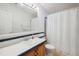 Bathroom with single vanity, shower/tub combo, and wood cabinets at 36750 Kimela Ave, Zephyrhills, FL 33542
