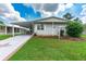 Mobile home with carport, star-shaped driveway, and landscaping at 36750 Kimela Ave, Zephyrhills, FL 33542