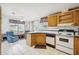Kitchen with island, wood cabinets, and a view into living area at 36750 Kimela Ave, Zephyrhills, FL 33542