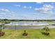 Serene lakefront view with lush landscaping and clear skies at 36750 Us Highway 19 N # 04308, Palm Harbor, FL 34684