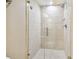 Large walk-in shower with glass enclosure and neutral tile at 36750 Us Highway 19 N # 04308, Palm Harbor, FL 34684