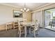 Bright dining area with glass-top table and four chairs, offering a view to a balcony at 36750 Us Highway 19 N # 04308, Palm Harbor, FL 34684