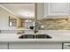 Kitchen sink with quartz countertops and a view into the dining area at 36750 Us Highway 19 N # 04308, Palm Harbor, FL 34684