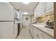 Modern kitchen with white cabinets, quartz countertops, and stainless steel appliances at 36750 Us Highway 19 N # 04308, Palm Harbor, FL 34684