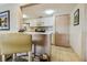 Kitchen with a breakfast bar and view into the living room at 36750 Us Highway 19 N # 04308, Palm Harbor, FL 34684