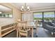 Dining area with glass-top table, chairs, and view to balcony overlooking golf course at 36750 Us Highway 19 N # 04308, Palm Harbor, FL 34684