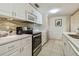 Modern kitchen with white cabinets, quartz countertops, and stainless steel appliances at 36750 Us Highway 19 N # 04308, Palm Harbor, FL 34684