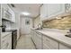 Modern kitchen with white cabinets, quartz countertops, and stainless steel appliances at 36750 Us Highway 19 N # 04308, Palm Harbor, FL 34684