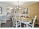 Dining area features a glass-top table, chairs, and a view into the kitchen at 36750 Us Highway 19 N # 04308, Palm Harbor, FL 34684