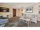 Living room with comfortable seating, coffee table, and large TV at 36750 Us Highway 19 N # 04308, Palm Harbor, FL 34684