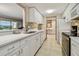 Modern kitchen with white cabinets, quartz countertops, and stainless steel appliances at 36750 Us Highway 19 N # 04308, Palm Harbor, FL 34684