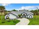 White house with gray roof, modern front door, and landscaped yard at 10 Belem St, Punta Gorda, FL 33983