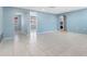 Open living area with light blue walls and tile floors at 1249 Viking Dr, Holiday, FL 34691