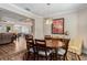 Elegant dining room with a wood table, seating for six, and views into the living and kitchen areas at 19879 Tattnall Way, Brooksville, FL 34601