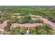 Aerial view showcases the community's buildings, surrounding trees, and serene pond at 5608 Pinnacle Heights Cir # 305, Tampa, FL 33624