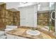 Bathroom featuring a tub with brown tiled walls, vanity with a sink, and a large mirror at 5608 Pinnacle Heights Cir # 305, Tampa, FL 33624