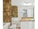 Well-lit bathroom featuring a shower with decorative brown tile and a single sink vanity at 5608 Pinnacle Heights Cir # 305, Tampa, FL 33624