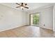 Bright bedroom featuring tile flooring, ceiling fan, and a sliding glass door to a balcony at 5608 Pinnacle Heights Cir # 305, Tampa, FL 33624