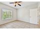 Bedroom with natural light from the window featuring neutral tile floors at 5608 Pinnacle Heights Cir # 305, Tampa, FL 33624