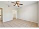 Bedroom showcasing neutral tile floors and a ceiling fan with ample closet space at 5608 Pinnacle Heights Cir # 305, Tampa, FL 33624