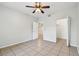 Open bedroom showcasing neutral tile floors, closet and door to additional spaces at 5608 Pinnacle Heights Cir # 305, Tampa, FL 33624